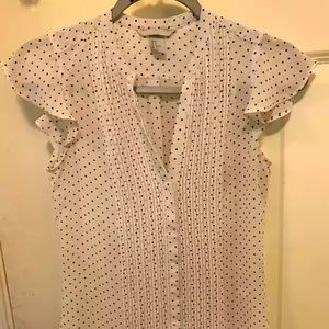 White V-neck blouse with black dotted pattern